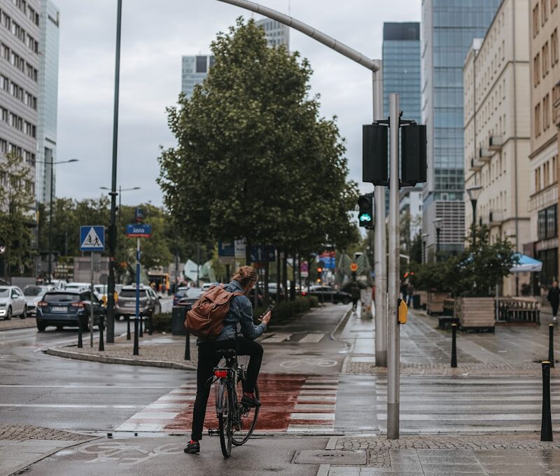 a person riding a bicycle on a city street