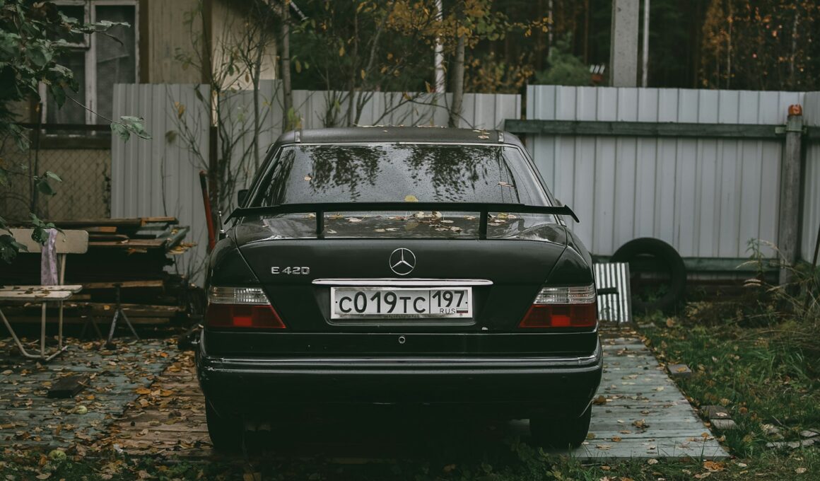 black audi a 4 parked near white wooden fence