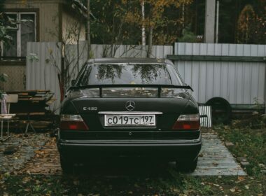 black audi a 4 parked near white wooden fence