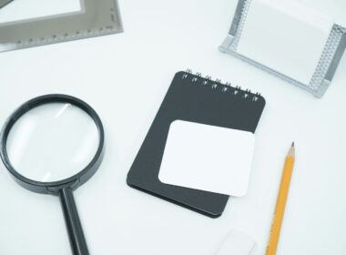 black magnifying glass on white paper